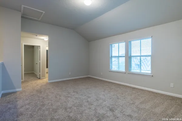 an empty room with a empty space and windows