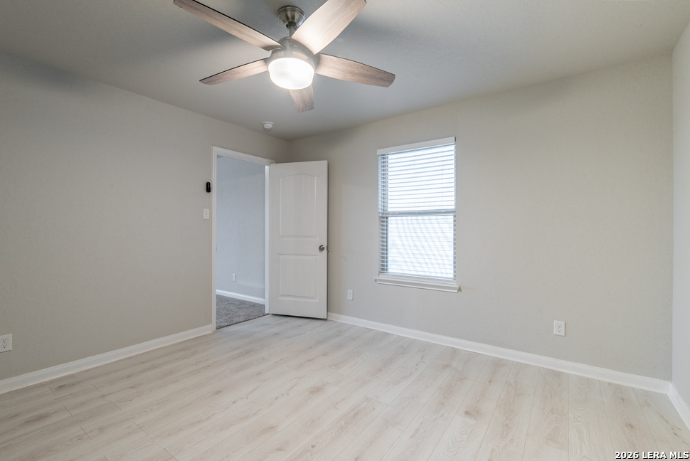 10230 Midsummer Meadow Converse, TX 78109 - Photo 25 of 37 an empty room with wooden floor ceiling fan and windows