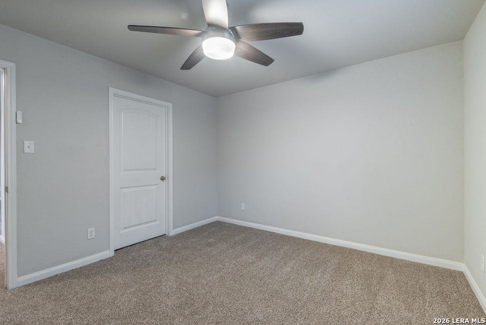 10230 Midsummer Meadow Converse, TX 78109 - Photo 27 of 37 an empty room with a chandelier fan and windows