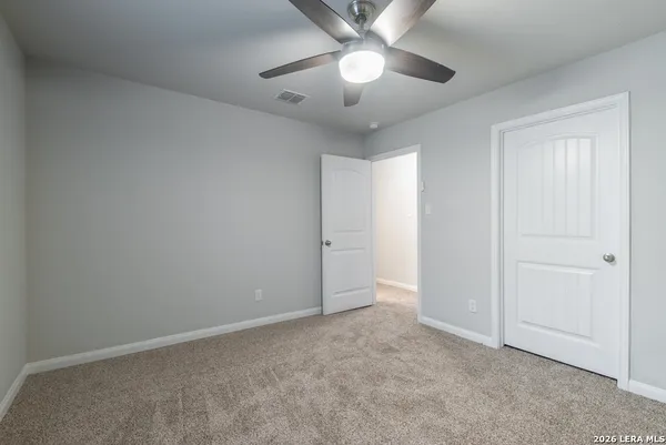 an empty room with a empty space and a ceiling fan