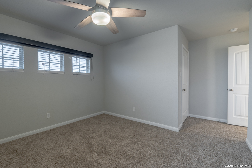 10230 Midsummer Meadow Converse, TX 78109 - Photo 30 of 37 an empty room with a chandelier fan and windows