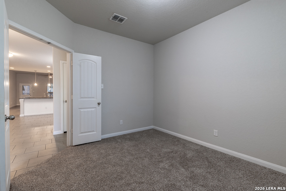 10230 Midsummer Meadow Converse, TX 78109 - Photo 3 of 37 wooden floor and cabinet in an empty room