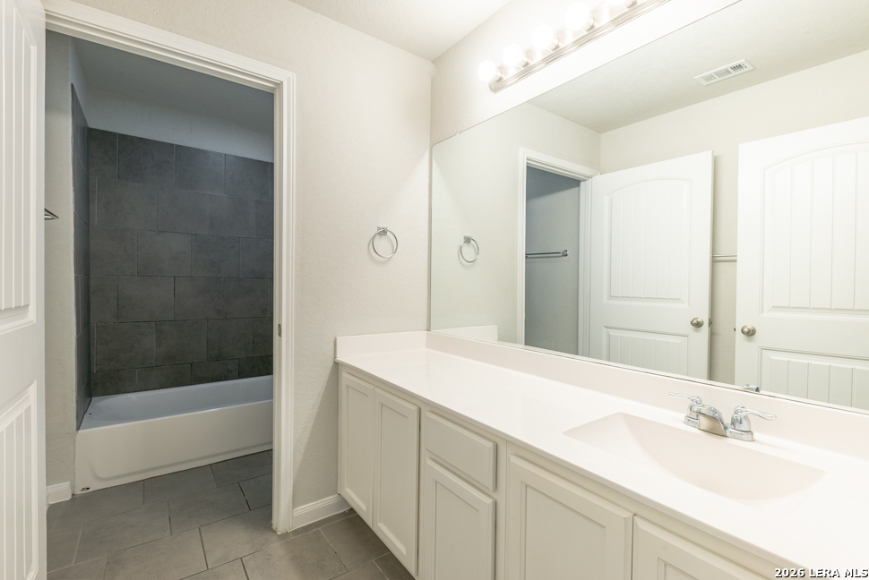 10230 Midsummer Meadow Converse, TX 78109 - Photo 32 of 37 a bathroom with a sink and a mirror