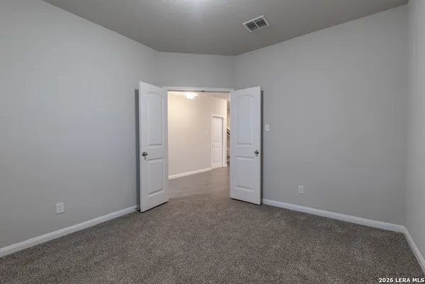 an empty room with closet area