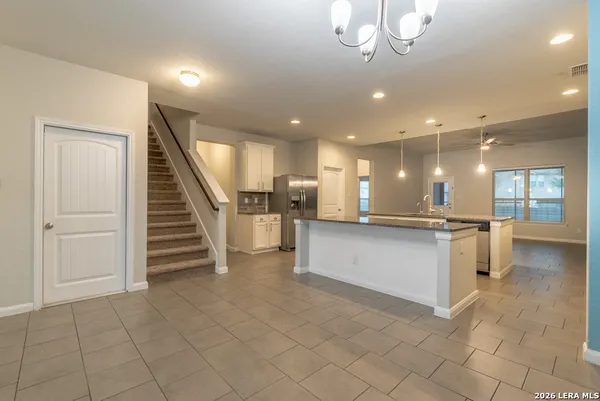 a view of kitchen with cabinets and window
