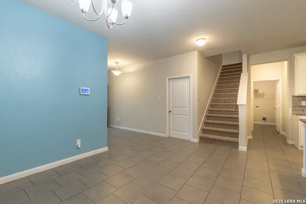 a view of an empty room with stairs and ventilation