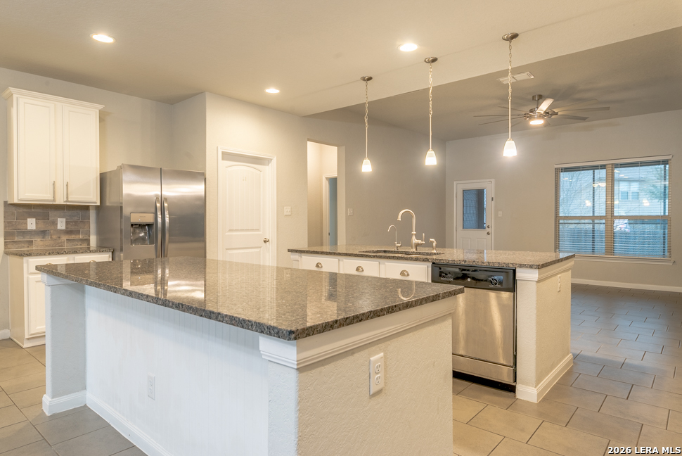 10230 Midsummer Meadow Converse, TX 78109 - Photo 9 of 37 a kitchen with stainless steel appliances granite countertop a sink a oven and a refrigerator