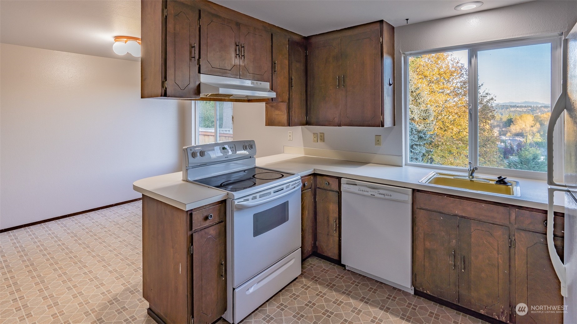 22527 4th Avenue Southeast Bothell, WA 98021 - Photo 21 of 40 a kitchen with stainless steel appliances granite countertop a sink stove and refrigerator