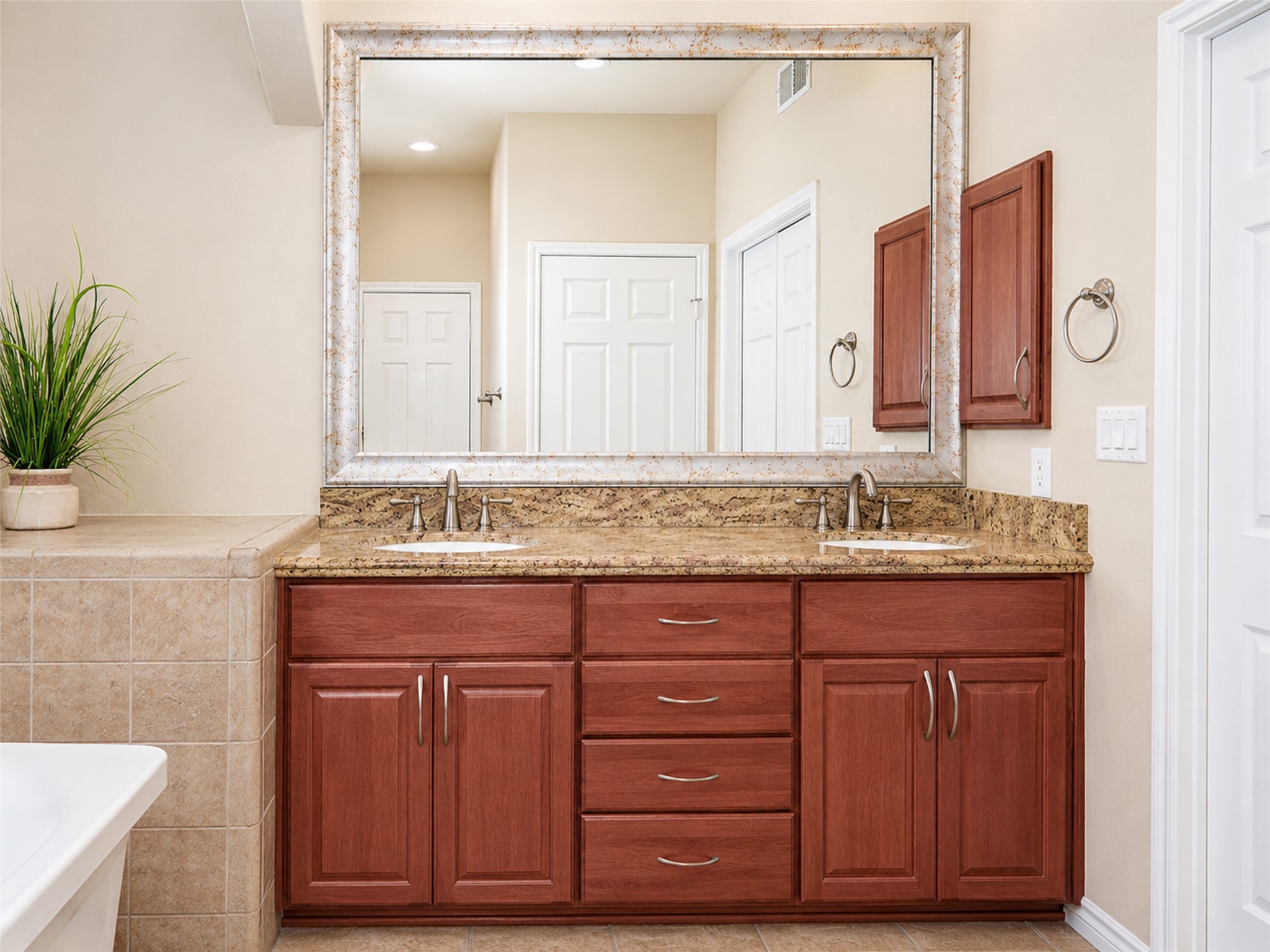 2400 McCue Road, Unit 401 Houston, TX 77056 - Photo 19 of 47 Primary bathroom with double vanity, medicine cabinet, linen closet, water closet, soaking tub, and walk-in shower.