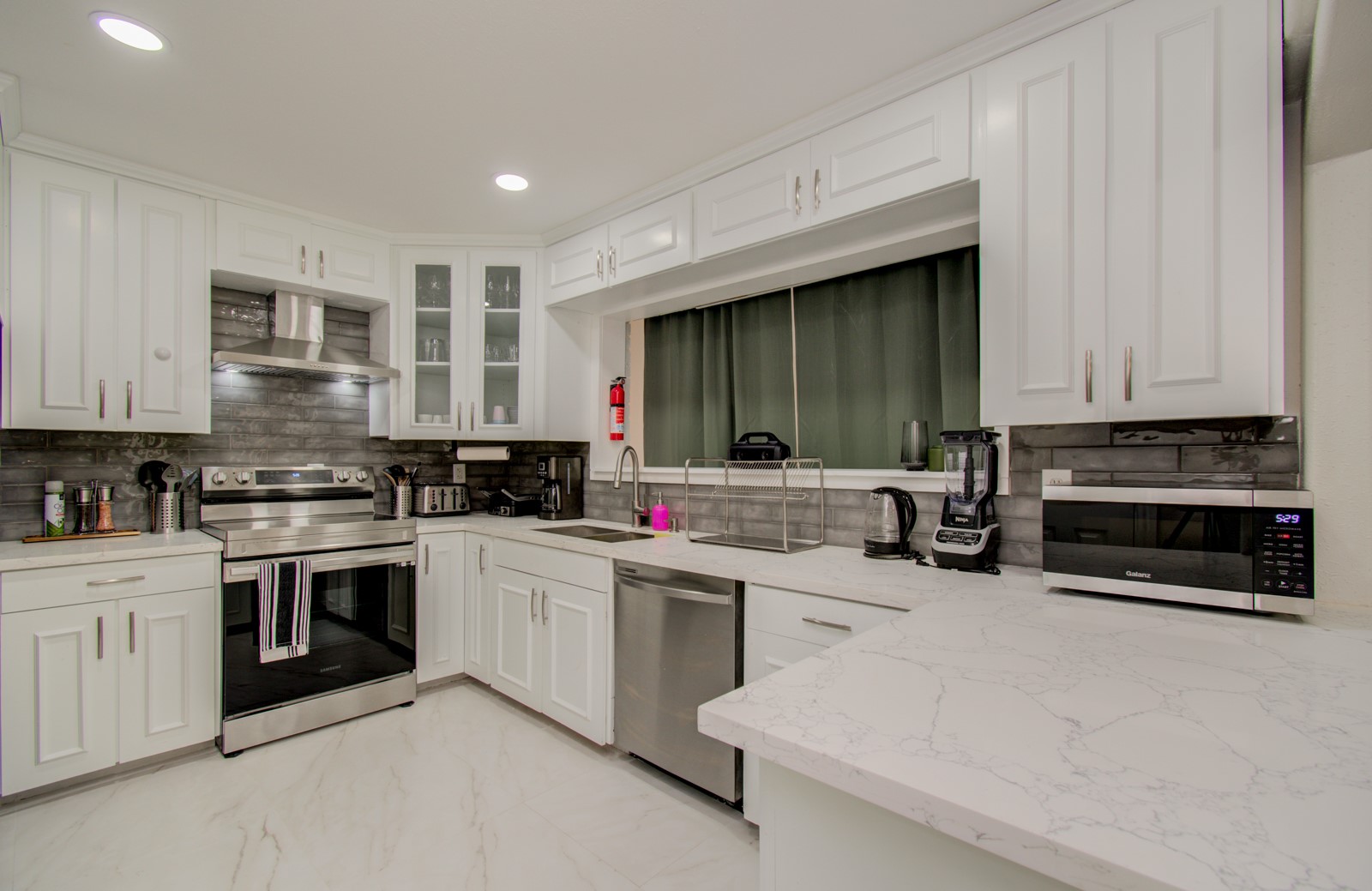 8623 Parasol Lane Houston, TX 77064 - Photo 11 of 50 a kitchen with white cabinets and appliances