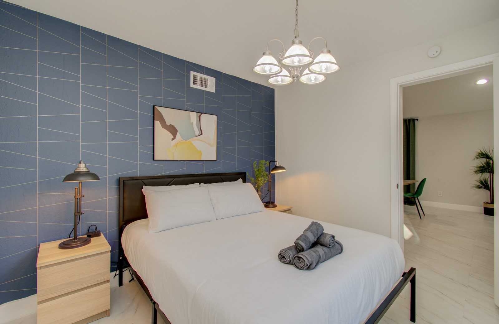 8623 Parasol Lane Houston, TX 77064 - Photo 24 of 50 a bedroom with a bed and a chandelier