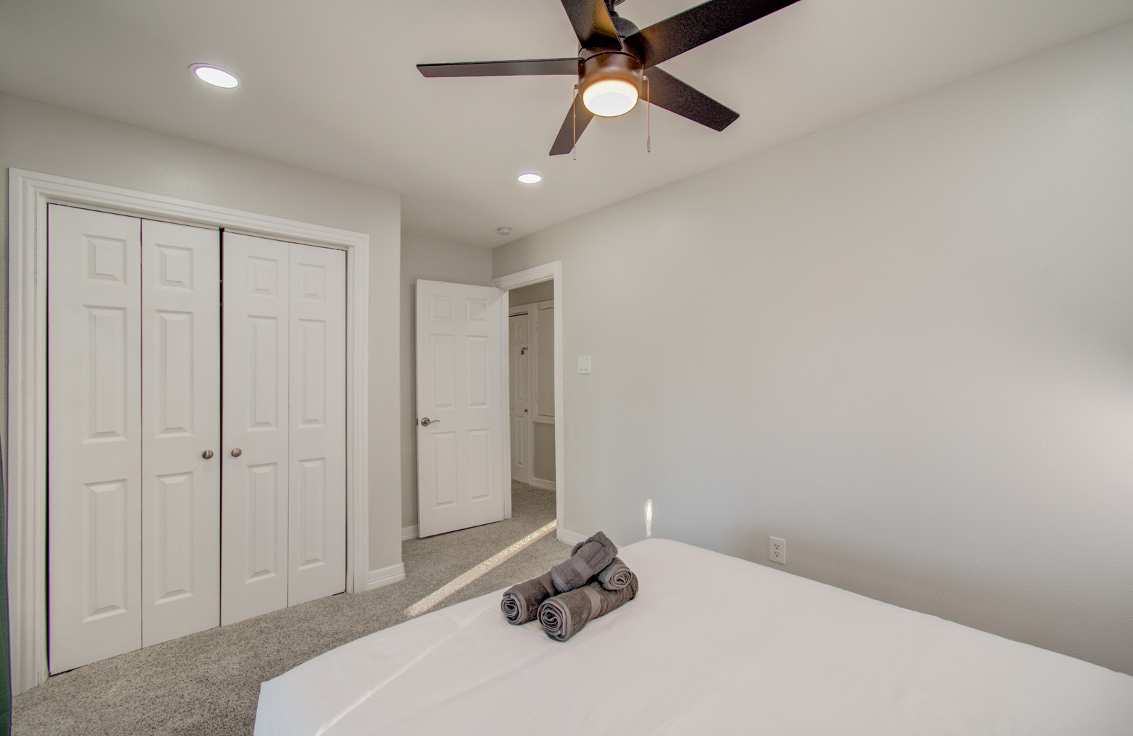 8623 Parasol Lane Houston, TX 77064 - Photo 27 of 50 a bedroom with a bed and a chandelier fan