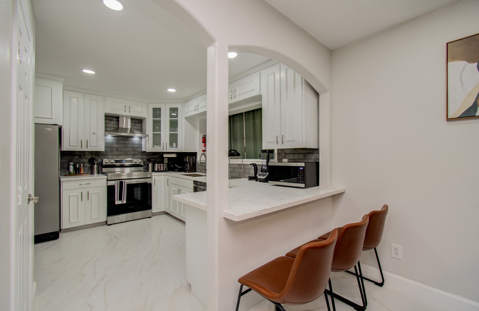 8623 Parasol Lane Houston, TX 77064 - Photo 9 of 50 a kitchen with granite countertop white cabinets and stainless steel appliances