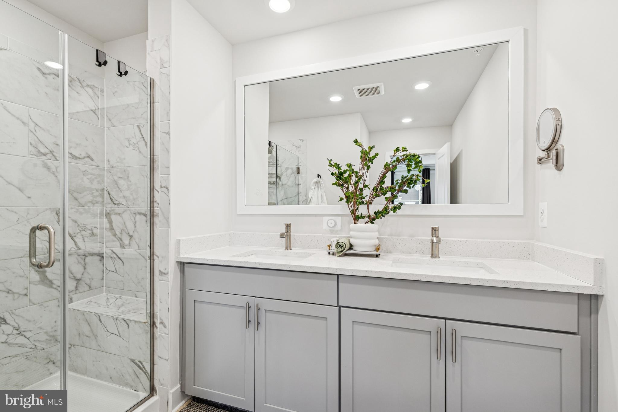 2218 Partin Road Baltimore, MD 21244 - Photo 32 of 62 a bathroom with a double vanity sink mirror and shower