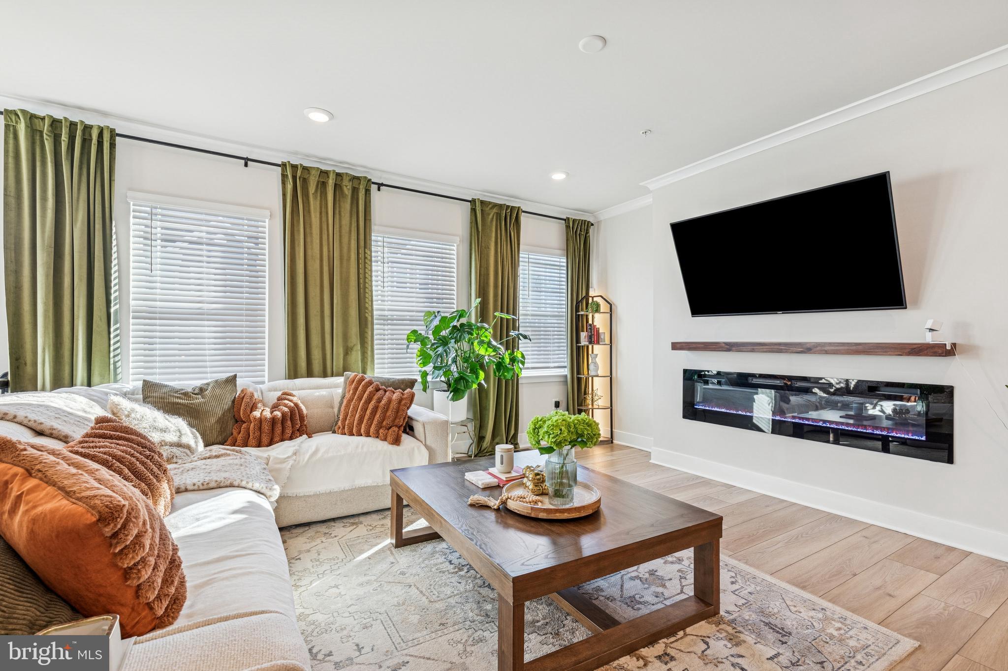 2218 Partin Road Baltimore, MD 21244 - Photo 6 of 62 a living room with furniture a flat screen tv and a large window