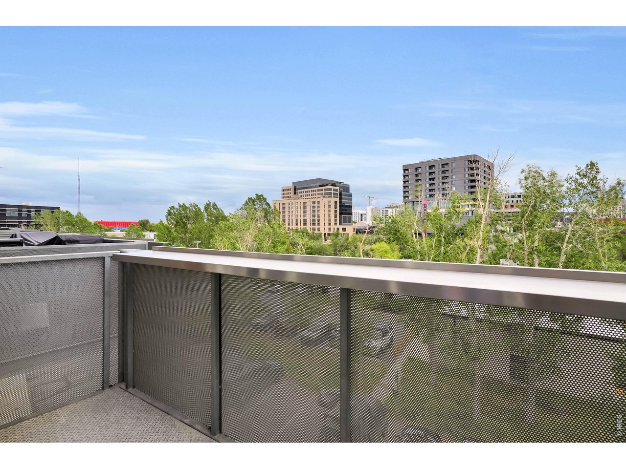 3457 Ringsby Court, Unit 327 Denver, CO 80216 - Photo 11 of 29 a terrace with a city view