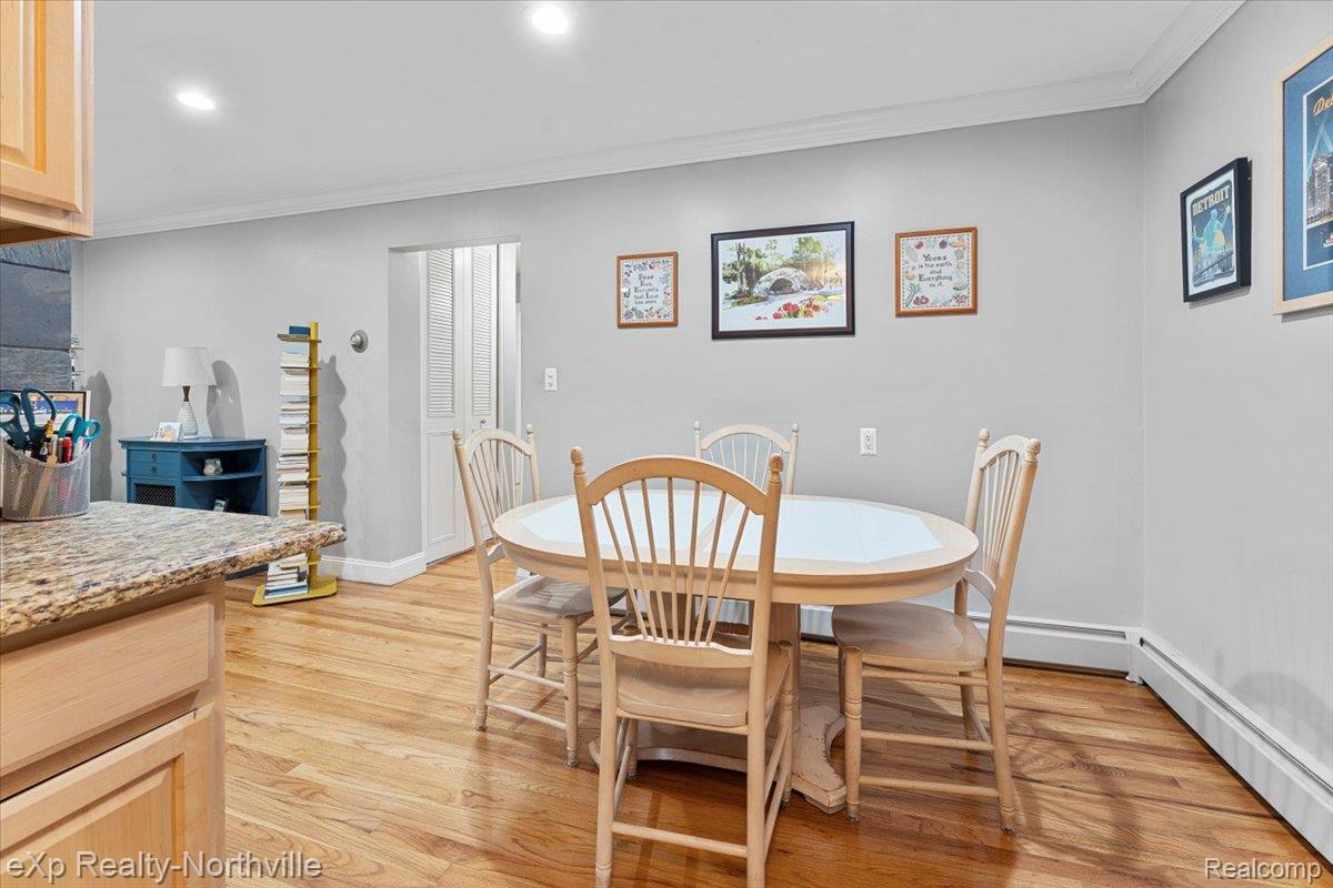 475 South Adams Road Birmingham, MI 48009 - Photo 12 of 23 Dining area with a baseboard radiator, ornamental molding, light wood finished floors, and recessed lighting