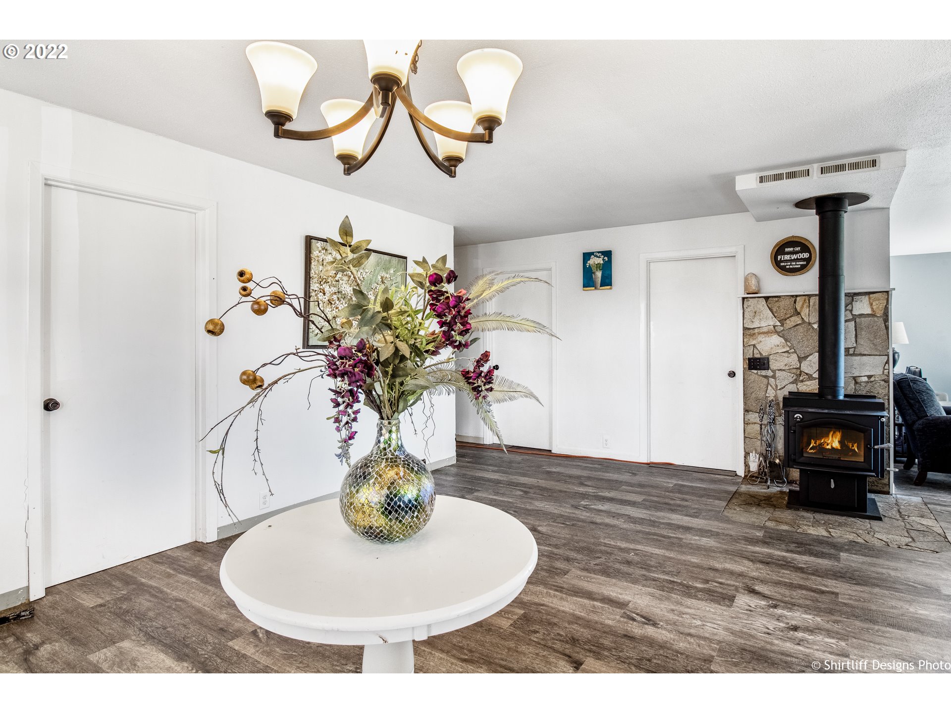 83553 Cloverdale Road Creswell, OR 97426 - Photo 7 of 17 a vase of flowers sitting on a table with a fireplace