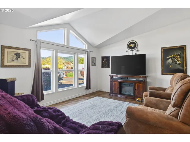 a kitchen with granite countertop a sink cabinets stainless steel appliances and a counter top space