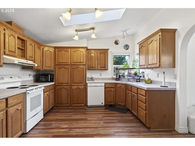 a kitchen with sink refrigerator and cabinets