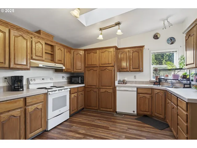 a kitchen with stainless steel appliances granite countertop a refrigerator sink and cabinets
