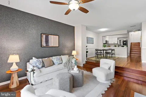 a living room with furniture a fireplace and a chandelier