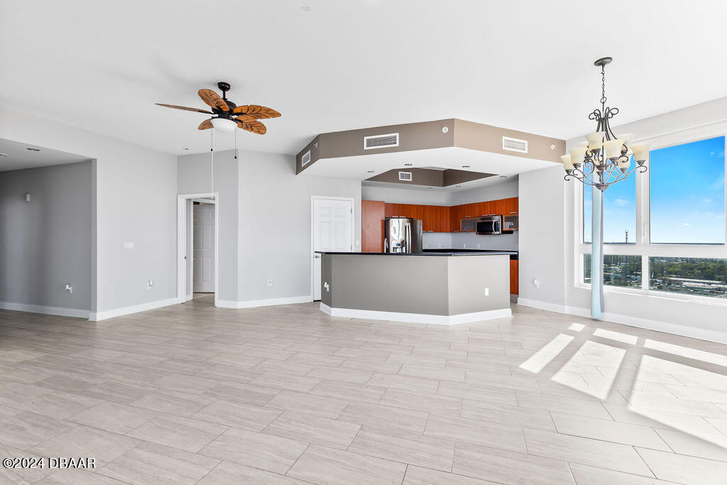 241 Riverside Drive, Unit 2610 Daytona Beach, FL 32117 - Photo 3 of 31 a view of a kitchen with a sink and a chandelier fan