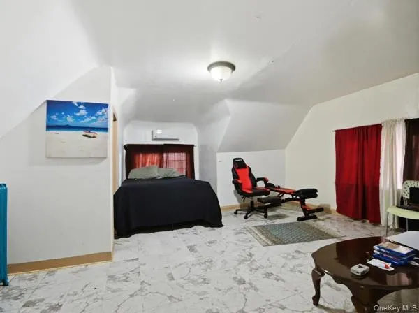 a bedroom with furniture and a flat screen tv