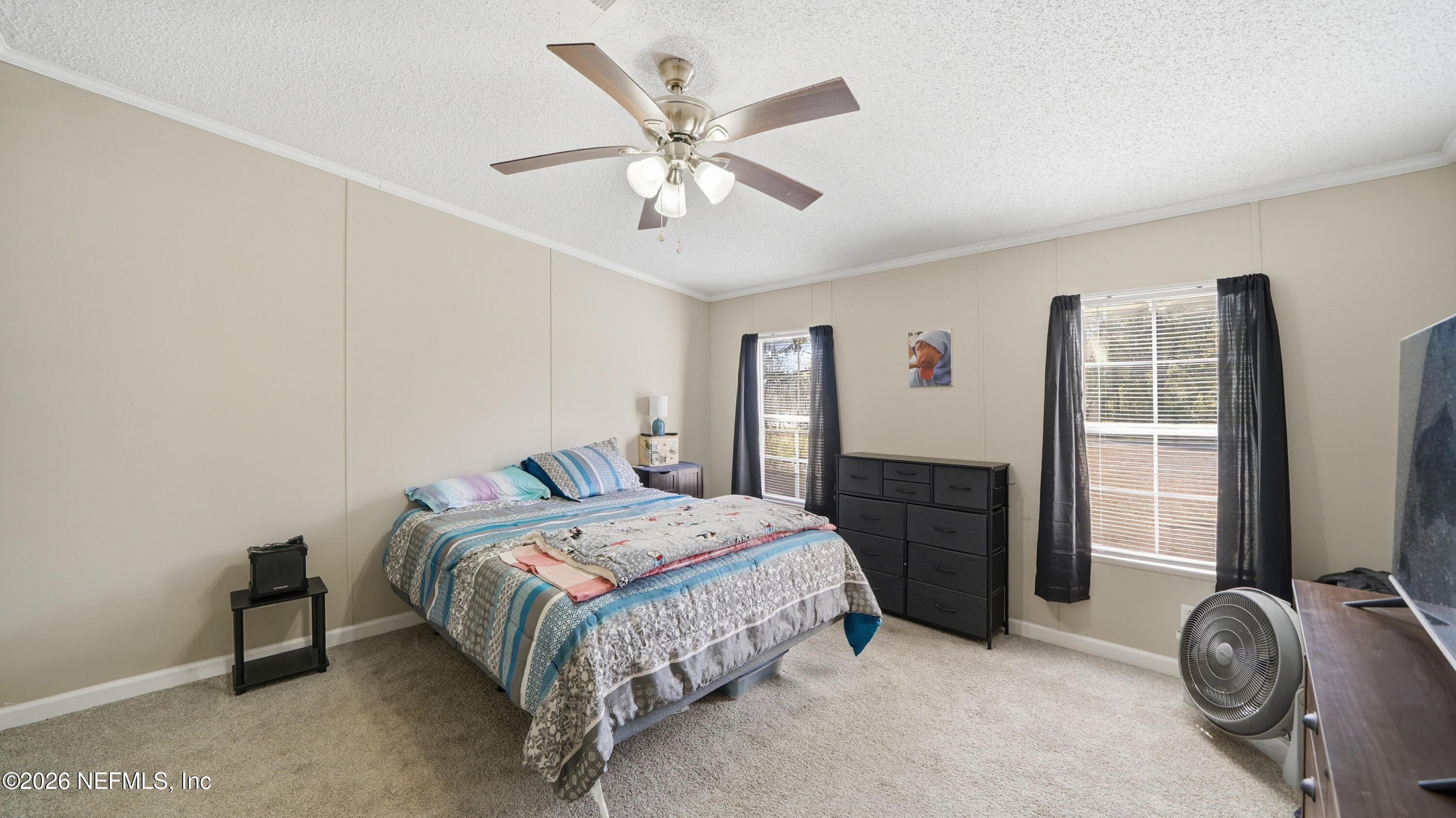 85324 Lil William Road Fernandina Beach, FL 32034 - Photo 14 of 36 a bedroom with a bed and a flat tv screen on dresser