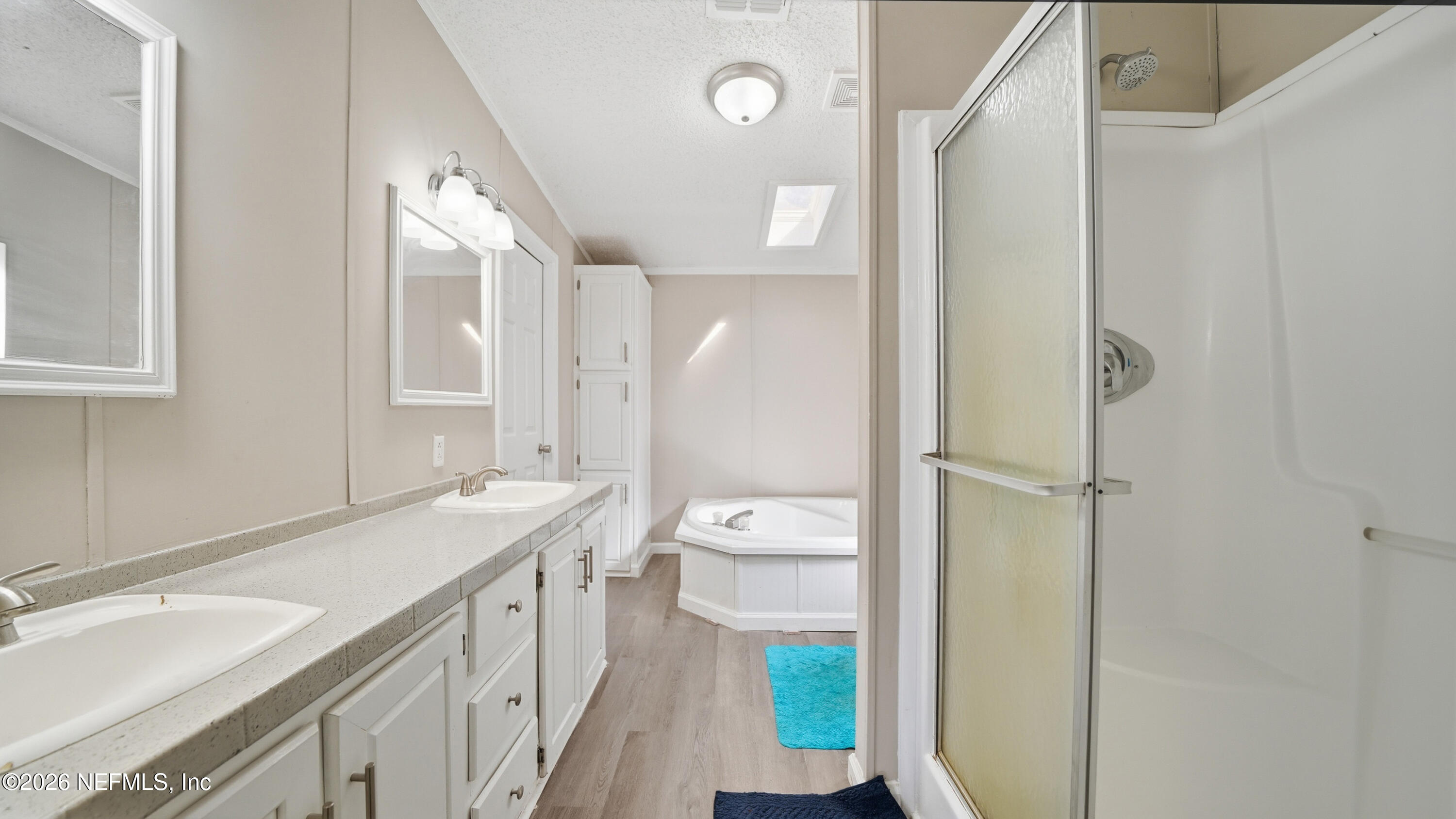 85324 Lil William Road Fernandina Beach, FL 32034 - Photo 16 of 36 a bathroom with a granite countertop sink mirror and a bathtub