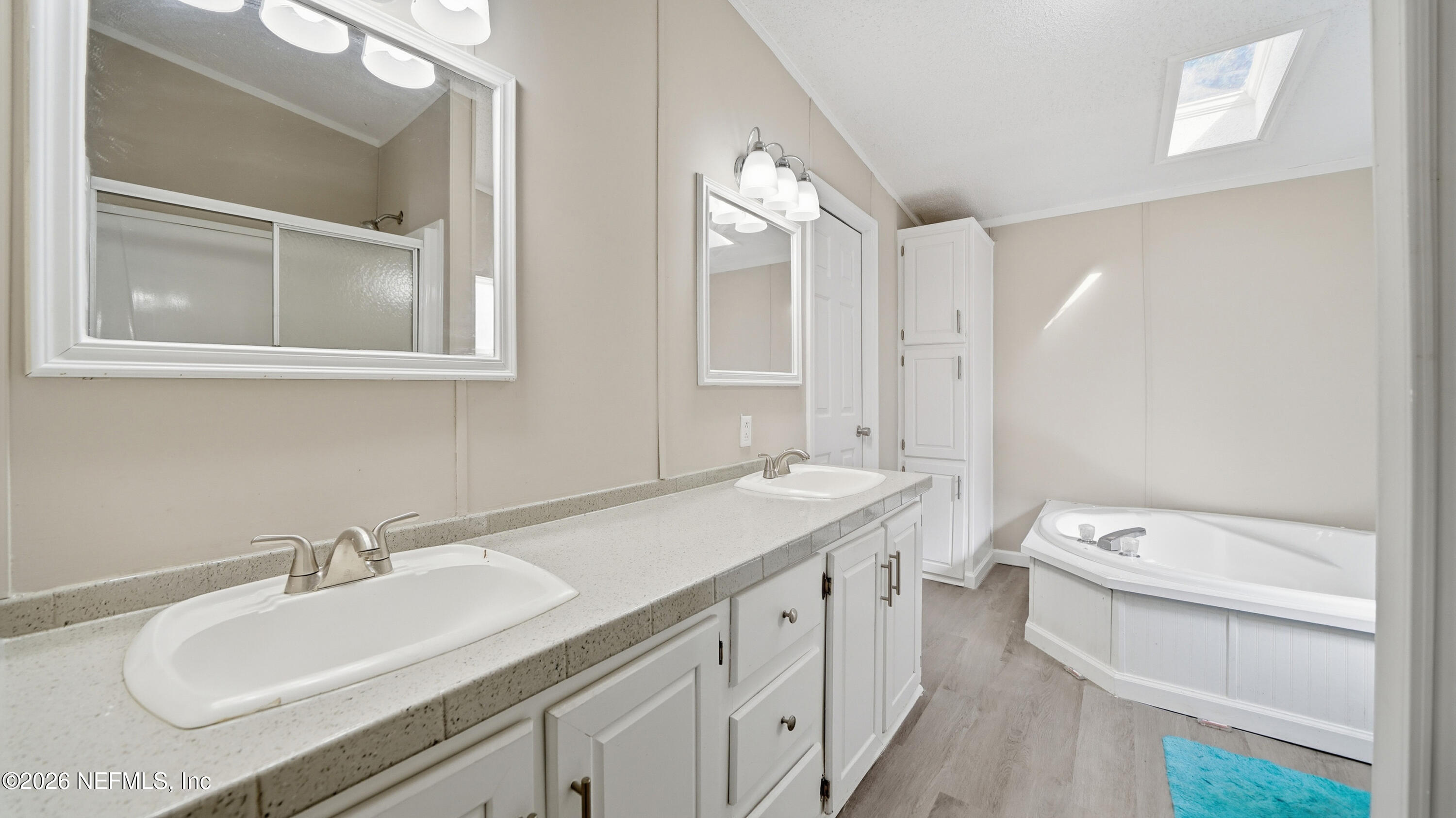 85324 Lil William Road Fernandina Beach, FL 32034 - Photo 17 of 36 a bathroom with a granite countertop sink mirror vanity and toilet