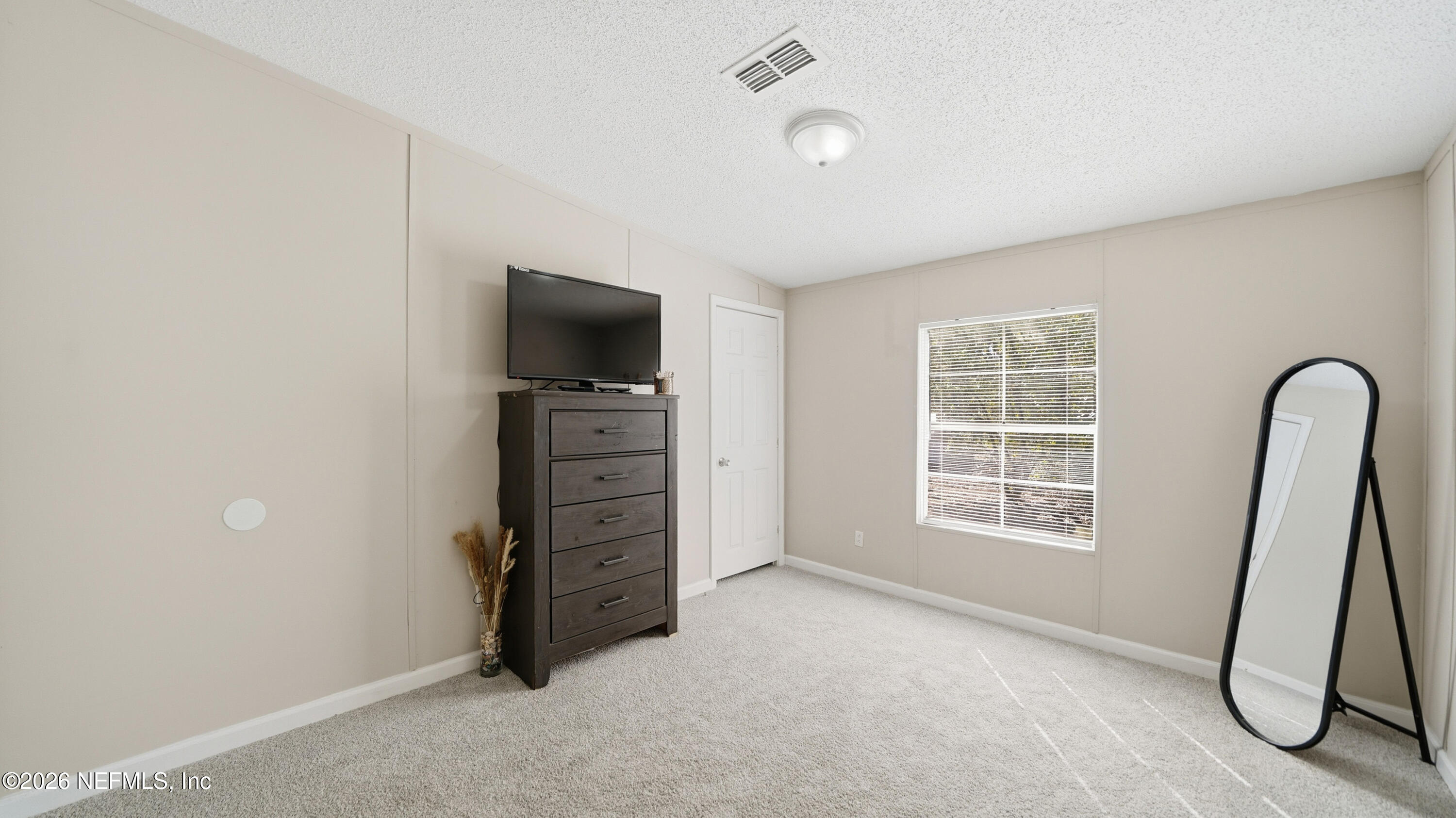 85324 Lil William Road Fernandina Beach, FL 32034 - Photo 22 of 36 an empty room with furniture and a window