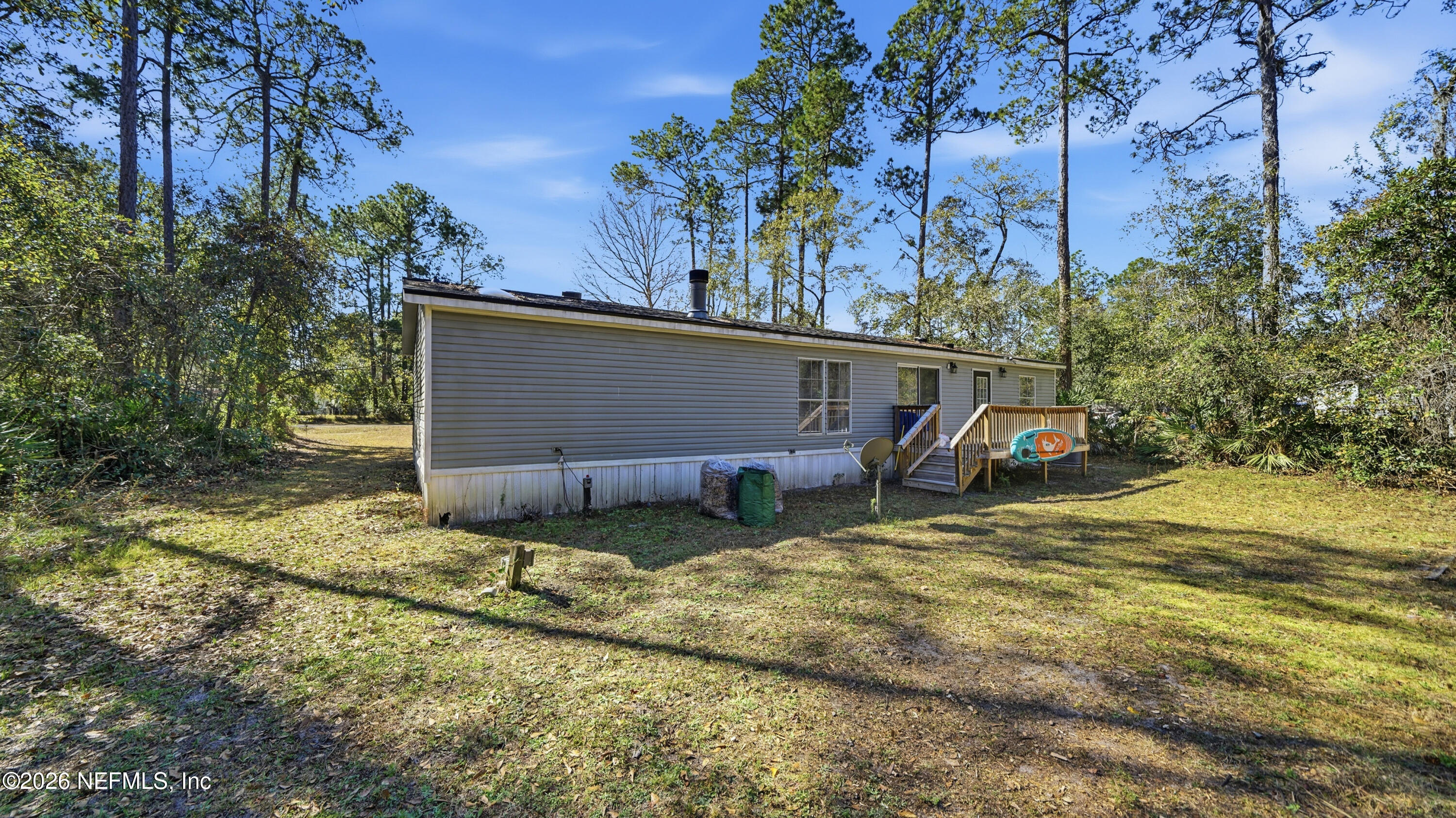 85324 Lil William Road Fernandina Beach, FL 32034 - Photo 30 of 36 a view of a house with backyard and trees
