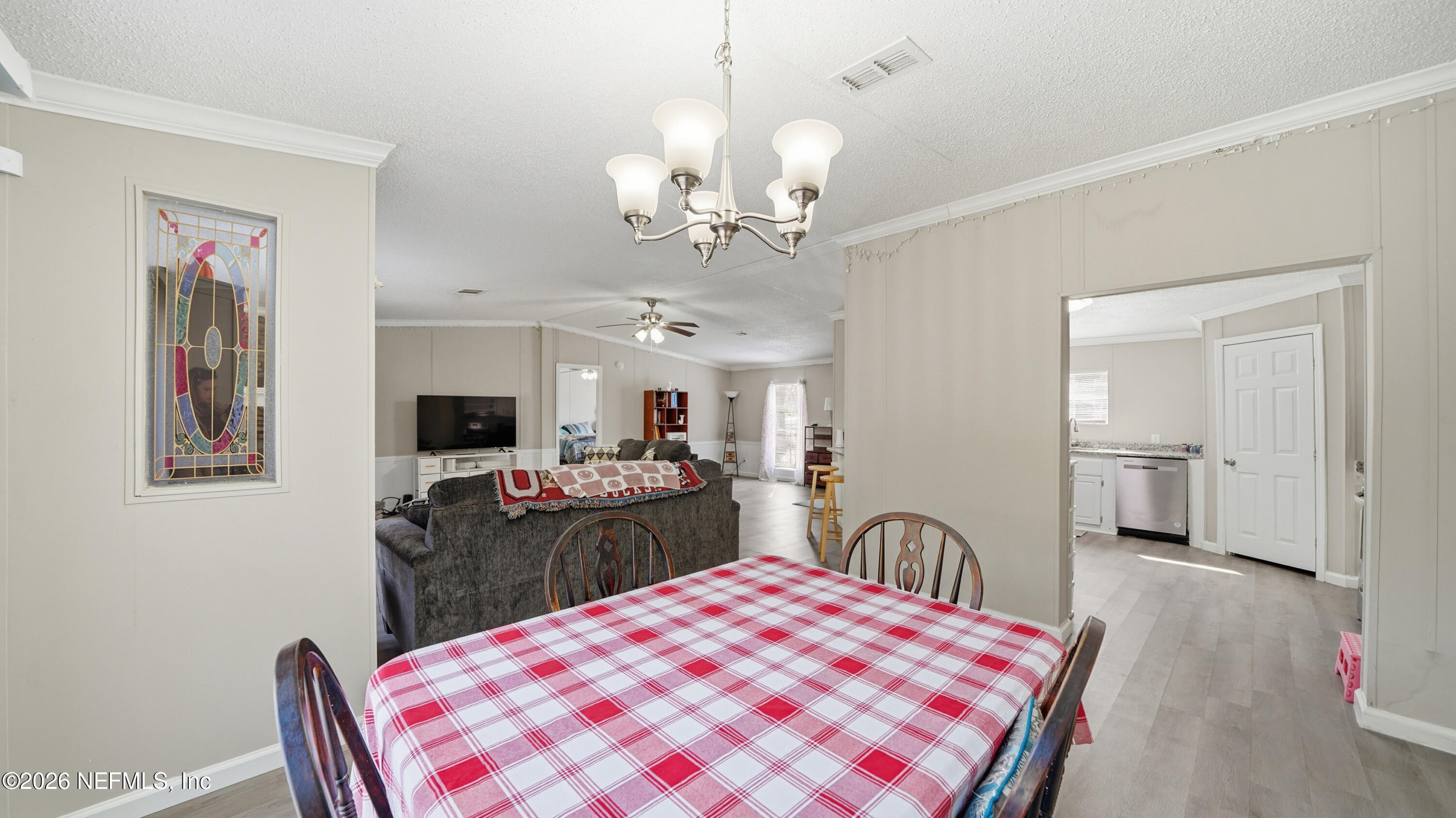 85324 Lil William Road Fernandina Beach, FL 32034 - Photo 10 of 36 a living room with furniture and a chandelier