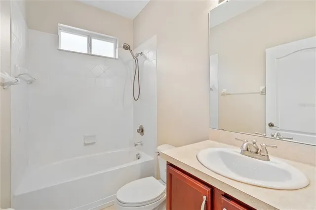 a bathroom with a sink toilet tub and shower
