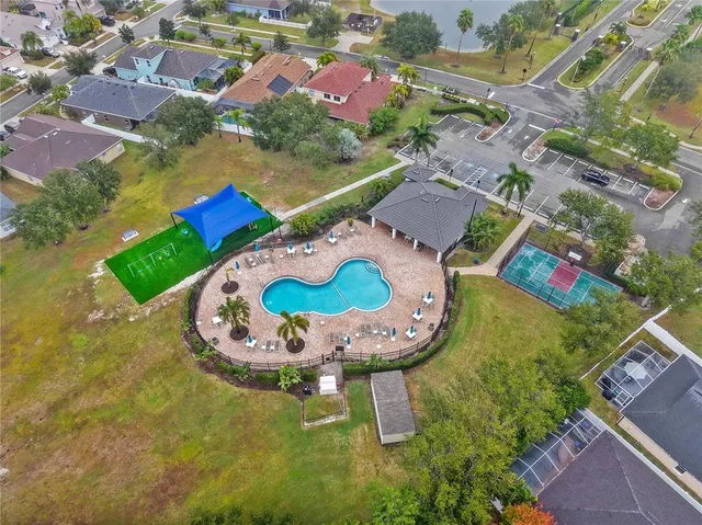 an aerial view of residential house with outdoor space and swimming pool