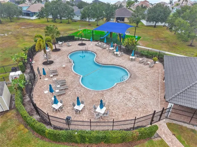 an aerial view of a house with outdoor space pool patio and lake view