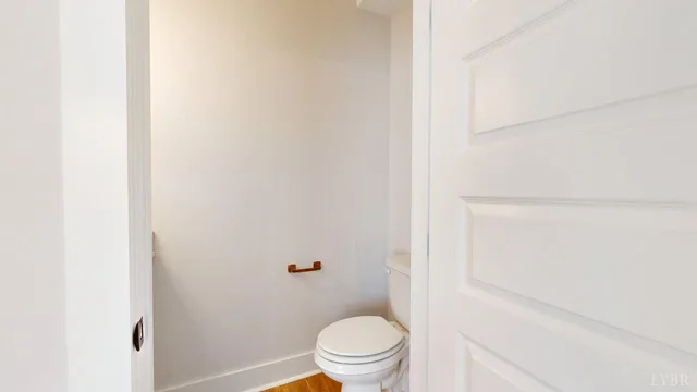 a white toilet sitting next to a shower