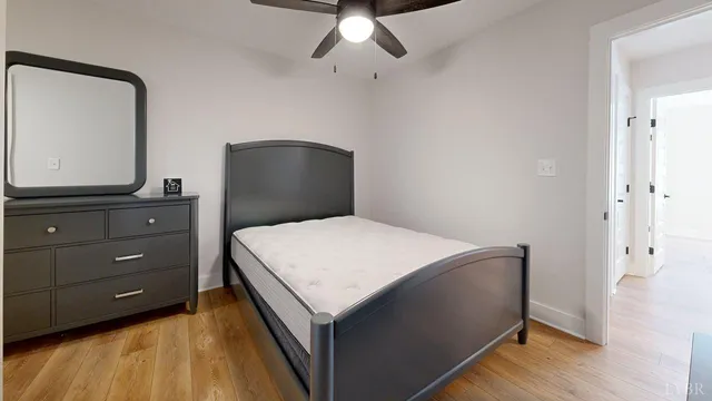 a bedroom with a bed and a dresser