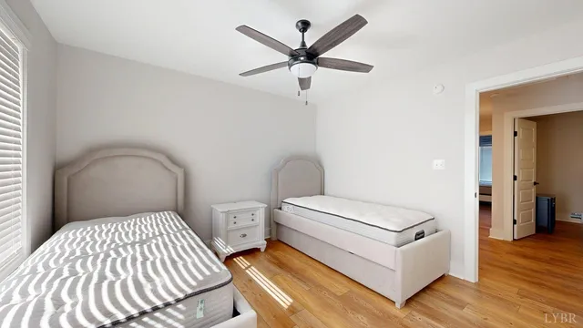 a bedroom with a bed and a ceiling fan