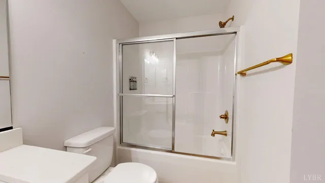 a bathroom with a toilet and a shower