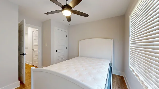 a bedroom with a bed and a chandelier