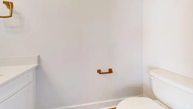 a white toilet sitting next to a white sink