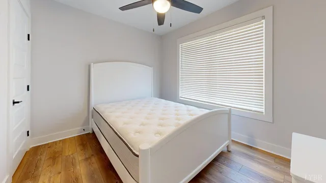a hallway with a bed and a chandelier