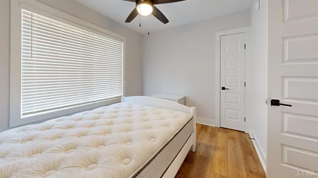 a spacious bedroom with a bed and a window