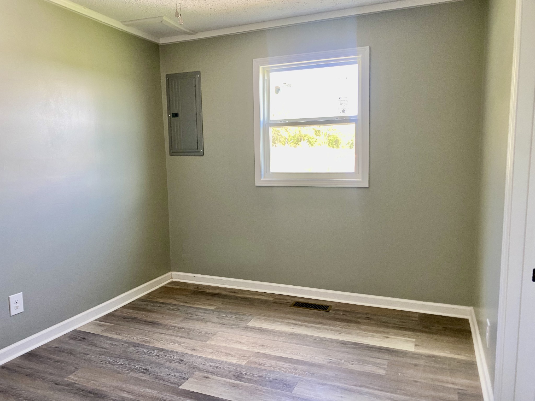 2471 Smartt Station Road Morrison, TN 37357 - Photo 19 of 38 a view of an empty room with wooden floor and a window