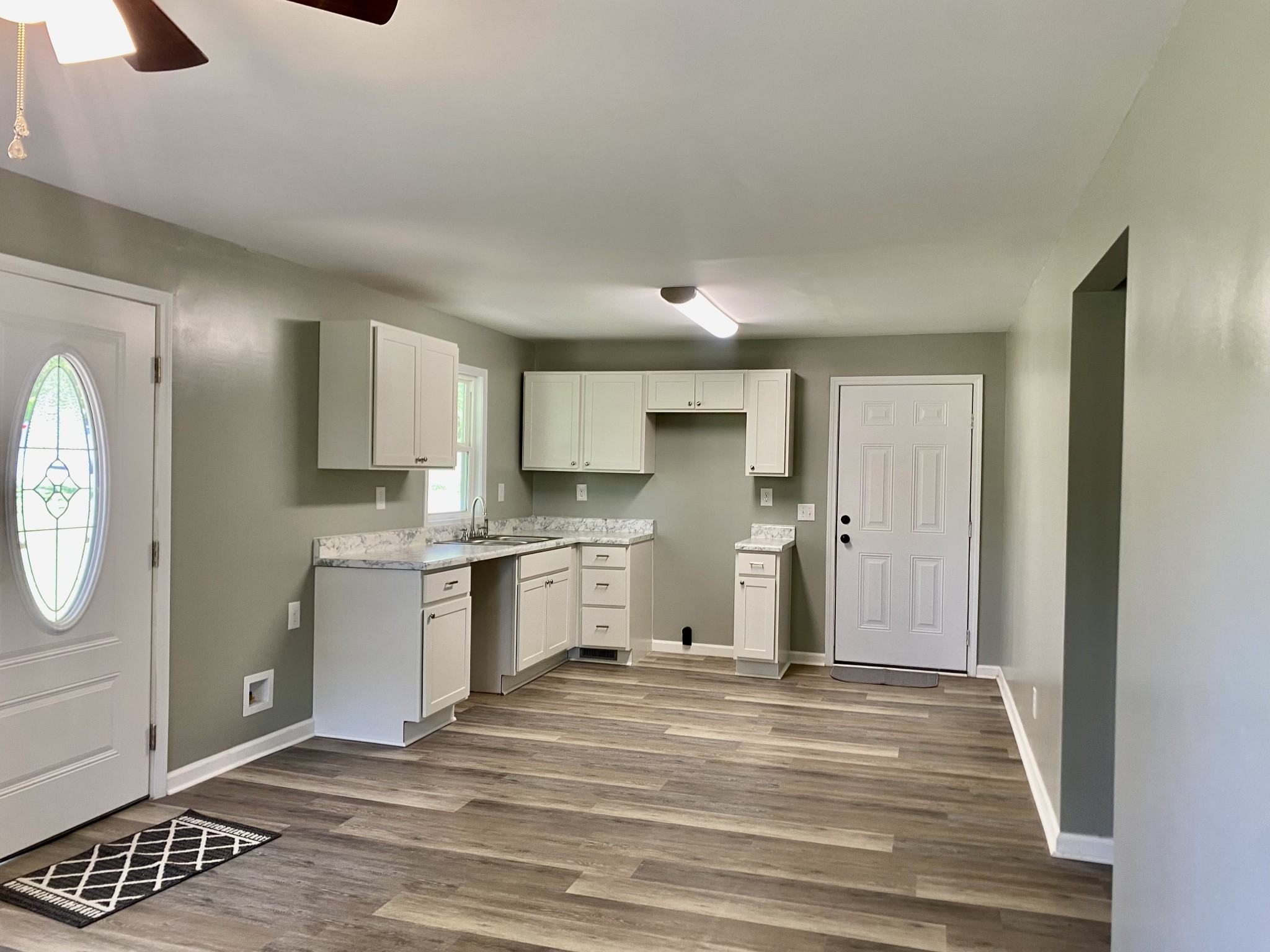 2471 Smartt Station Road Morrison, TN 37357 - Photo 5 of 38 a view of a kitchen with a sink and dishwasher a refrigerator with wooden floor