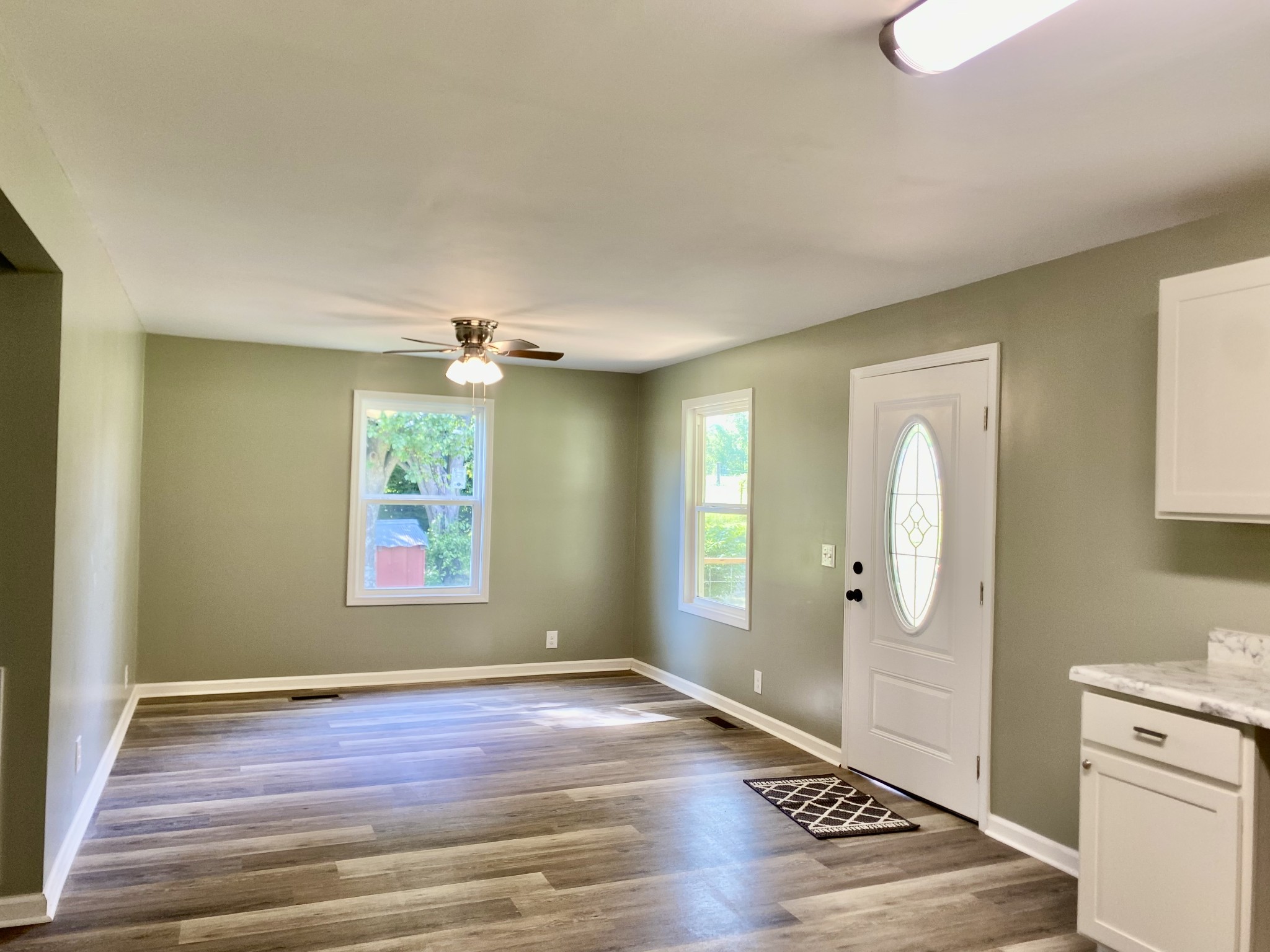 2471 Smartt Station Road Morrison, TN 37357 - Photo 6 of 38 a view of an empty room with wooden floor and a window