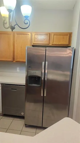 a kitchen with a refrigerator and a stove