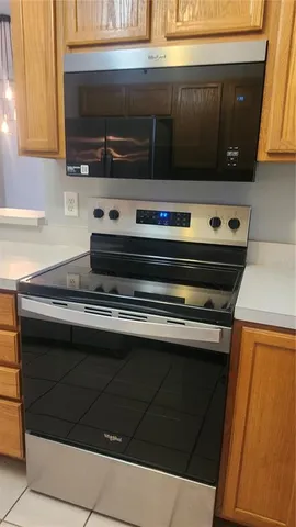a stove top oven sitting inside of a kitchen